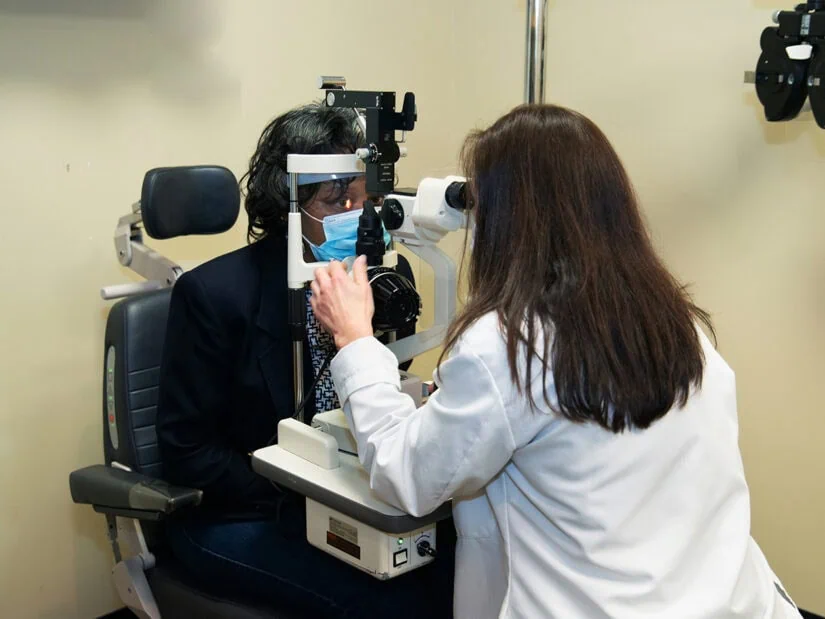 A doctor examines a patient's eyes.